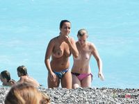 Beautiful brunette enjoys sitting topless, with her stunning, large, natural breasts on display 4