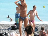 Beautiful brunette enjoys sitting topless, with her stunning, large, natural breasts on display 4
