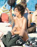 Beautiful brunette enjoys sitting topless, with her stunning, large, natural breasts on display 4