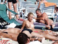 Blonde nudist woman lays at the beach 2