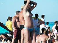 Two breathtaking brunettes with tight, fit bodies and beautiful, natural breasts walk around topless and lie down sunbathing 4