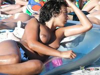 Two breathtaking brunettes with tight, fit bodies and beautiful, natural breasts walk around topless and lie down sunbathing 4
