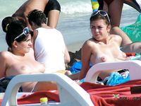 She covers her firm breasts and soft pussy in sunscreen before lying down with her ass showing 4