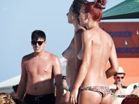 Naturist couple loves to play with each other on the beach, and the girl looks so tempting when she's topless and wears tiny, sexy, black thongs