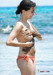 Chubby nudist at a naked beach has some fun in the sea 2