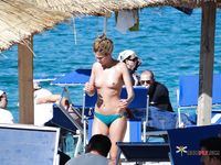 Nudist girl with thin body but fantastic big tits enjoys her time at a naked beach 2