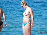 Nudist girl with thin body but fantastic big tits enjoys her time at a naked beach 2