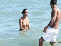 Adorable brunette filmed sunbathing topless during a hot summer day 2