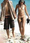 Sexy brown-haired girl loves reading magazines while she lies naked on a beach in a nudist park 2