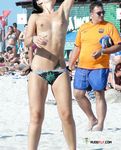 Busy Beach Path for a Confident Topless Walk Among Sunbathers