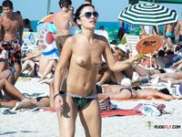 Busy Beach Path for a Confident Topless Walk Among Sunbathers