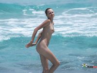 Nude Figure Walks the Shore as Ocean Waves Break Nearby