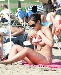 She gets caught on camera sitting topless to tan her slim body and a pair of beautiful, large, natural breasts 4