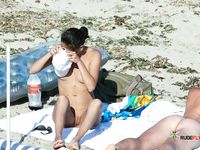 Nudist MILF blonde is getting intimate with her husband by the sea as he gently touches her tight ass while they are having a laugh