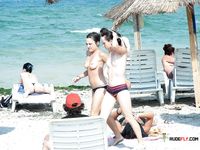 She gets filmed by a voyeur sitting down topless and sunbathing her slim body with tiny, firm tits 4