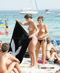 Colorful Umbrellas Frame a Busy Topless Beach Afternoon