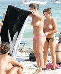 Colorful Umbrellas Frame a Busy Topless Beach Afternoon