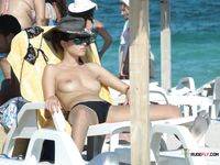 One brunette nudist girl at a nudist resort decides to hang around almost naked today 2