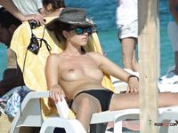 One brunette nudist girl at a nudist resort decides to hang around almost naked today 2