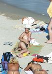 Tanned nudist hottie relaxes in the sun and enjoys a hot summer day at the beach