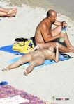 Tanned nudist hottie relaxes in the sun and enjoys a hot summer day at the beach