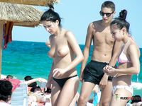 Voyeur sets up a hidden camera to film nudist babes taking an outdoor shower at the beach 2