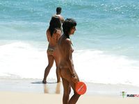 The sun is tantalizing this good looking naked babe while she lies on her towel at the beach in the nudist resort, but it seems like she likes it 2