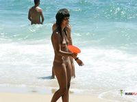 The sun is tantalizing this good looking naked babe while she lies on her towel at the beach in the nudist resort, but it seems like she likes it 2