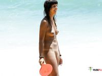 The sun is tantalizing this good looking naked babe while she lies on her towel at the beach in the nudist resort, but it seems like she likes it 2