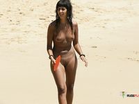 The sun is tantalizing this good looking naked babe while she lies on her towel at the beach in the nudist resort, but it seems like she likes it 2