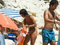 The sun is tantalizing this good looking naked babe while she lies on her towel at the beach in the nudist resort, but it seems like she likes it 2