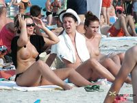 Naughty brunette caught by a voyeur sunbathing at a nudist beach 2