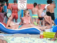 Naughty brunette caught by a voyeur sunbathing at a nudist beach 2