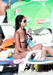 Skinny brunette with a fit body plays tennis with her perky tits out while other girls sunbathe topless 4