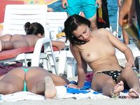 Voyeur catches a dashing nudist babe sunbathing naked on the beach 2