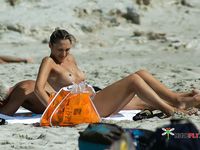 Playful naturist babes caught on a hidden camera enjoying a hot summer day at the beach 2