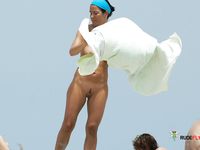 Busty nudist lady at a naked beach is just hanging around with her boobs out 2