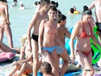 Chubby nudist mom is walking around the nudist camp while displaying her perfect tits and shave pussy while her family is having fun in the sea 2