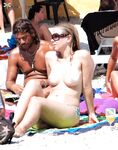 She Wades Into Refreshing Waves in Bikini Bottoms Only