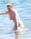 She Wades Into Refreshing Waves in Bikini Bottoms Only