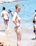 She Wades Into Refreshing Waves in Bikini Bottoms Only