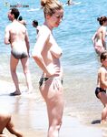 She Wades Into Refreshing Waves in Bikini Bottoms Only