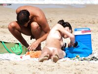 A model relaxing on the beach, perfectly at home in her own skin.