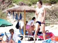 A lady enjoying the refreshing sea breeze in a natural, topless state. 2