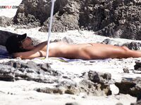 A lady enjoying the refreshing sea breeze in a natural, topless state. 2