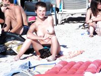 Basking in the intense heat of the shore while enjoying a clothing-optional lifestyle.