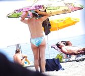 Two Nude Women Stroll a Quiet Pebble Beach