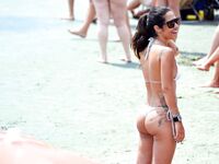 Two Nude Women Stroll a Quiet Pebble Beach