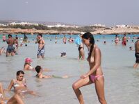 She Walks Through Shallow Water in Pink Bikini Bottoms