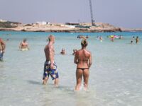 She Walks Through Shallow Water in Pink Bikini Bottoms